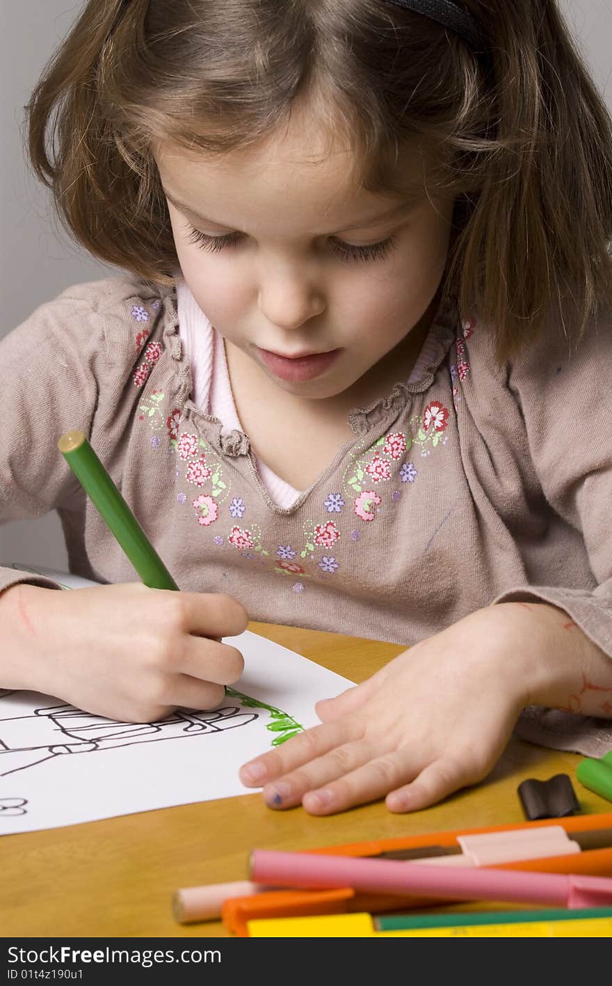 Girl drawing with coloured pens