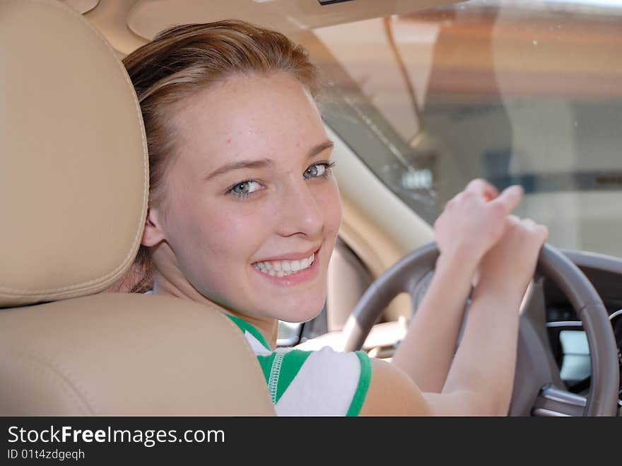 Teen behind steering wheel of a car