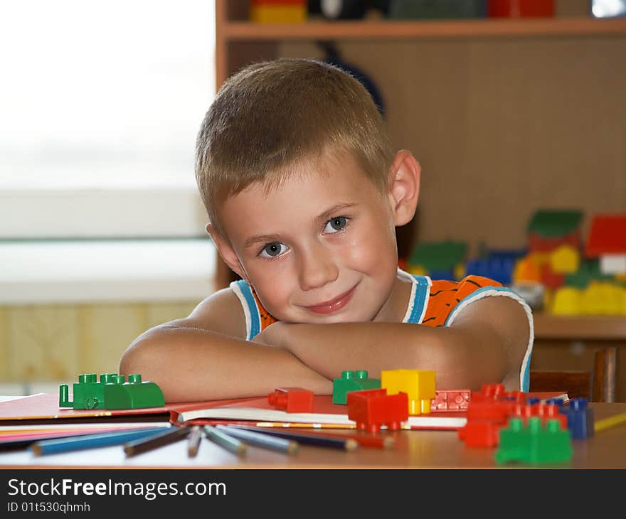 The boy of 7 years is engaged in a children's room