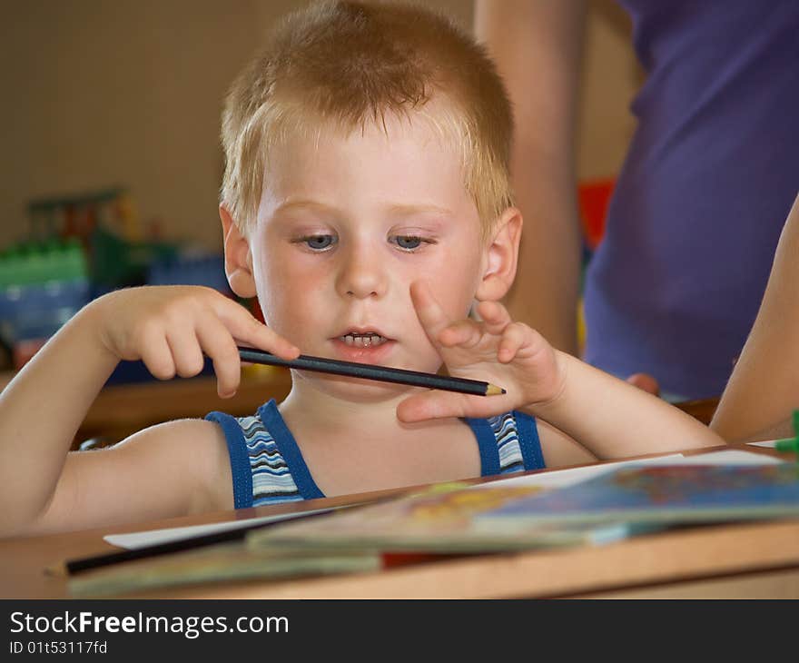 The boy of 2 years is engaged in a children's room