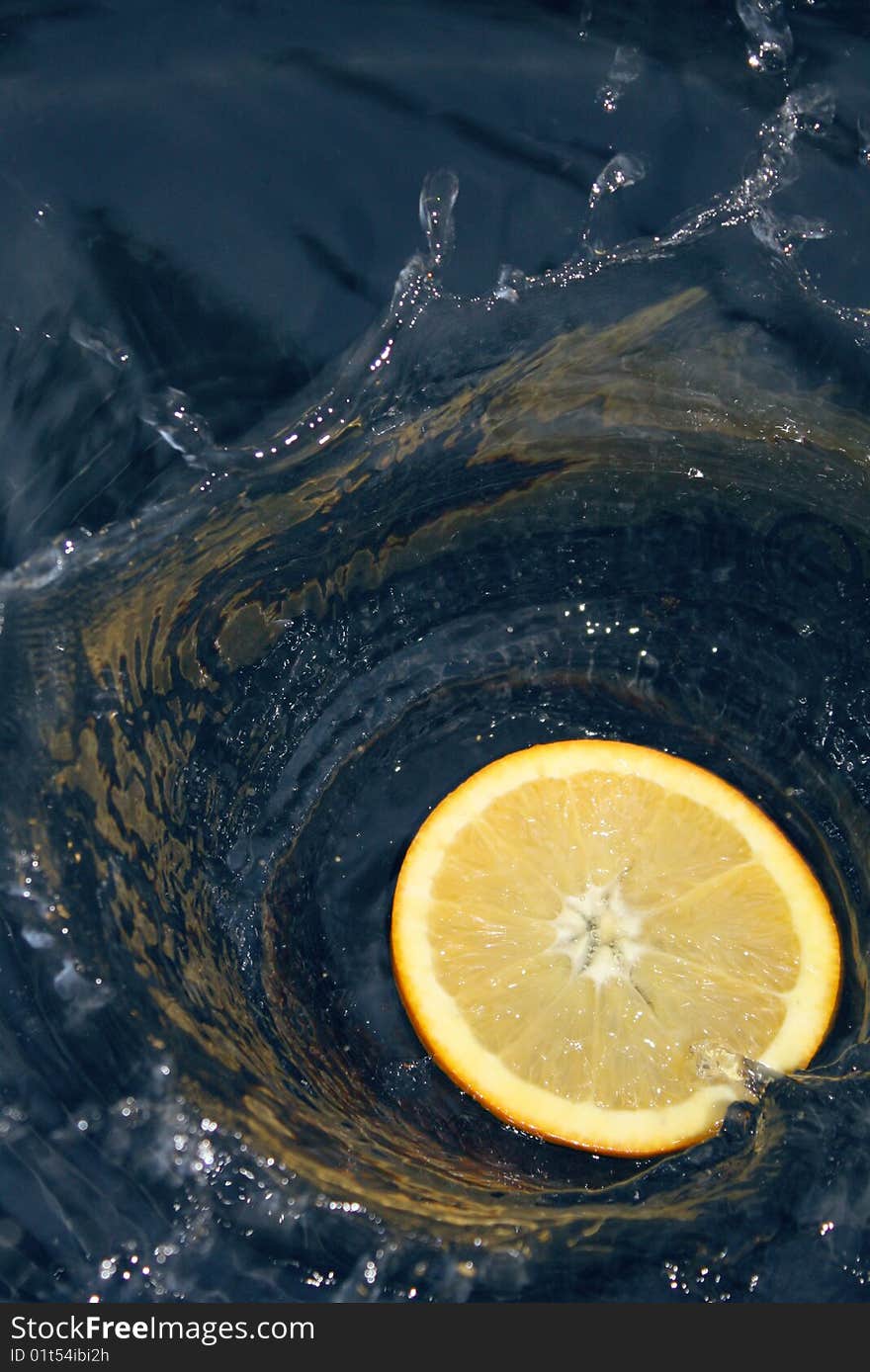 Orange slice splashing in water. Orange slice splashing in water