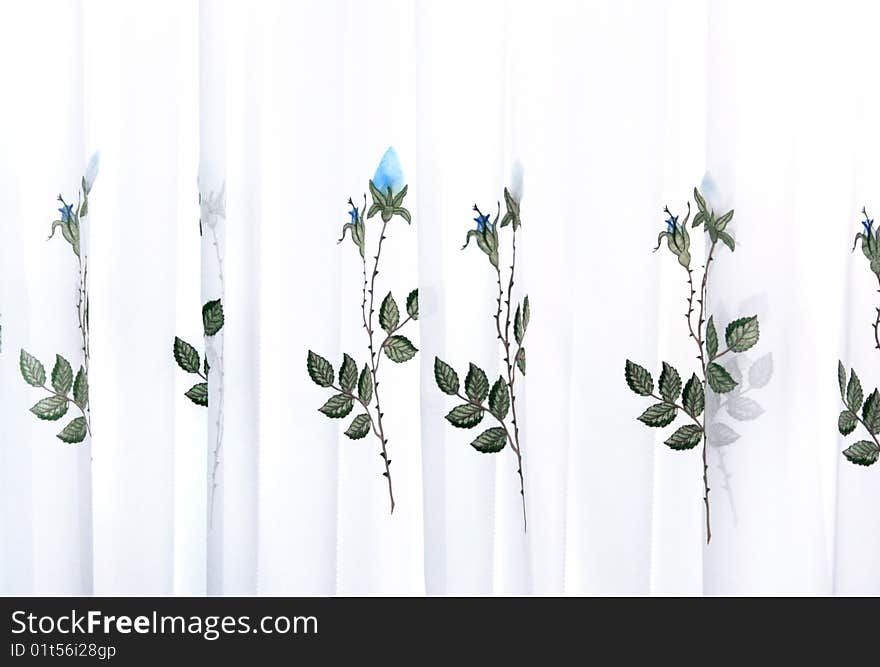 Picture of luxurious curtains with blue roses.