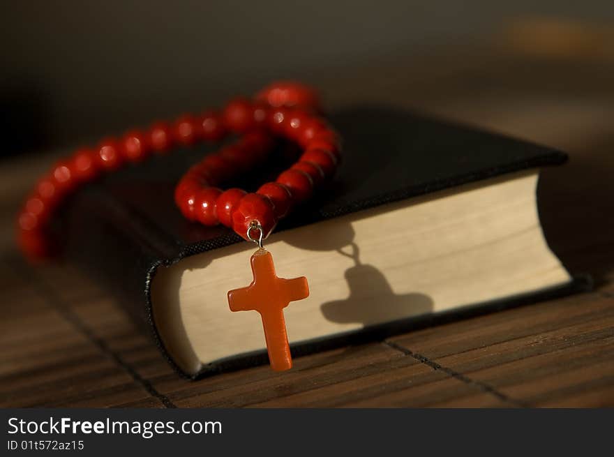 Book and red beads with cross. Book and red beads with cross