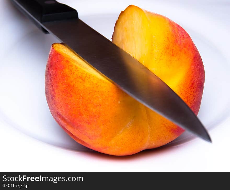 Ripe peach knifed