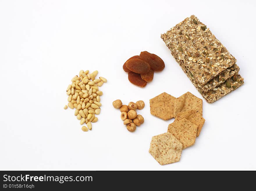 Collection of pine-nuts, fiber crackers, dried apricots and hazelnuts. Collection of pine-nuts, fiber crackers, dried apricots and hazelnuts