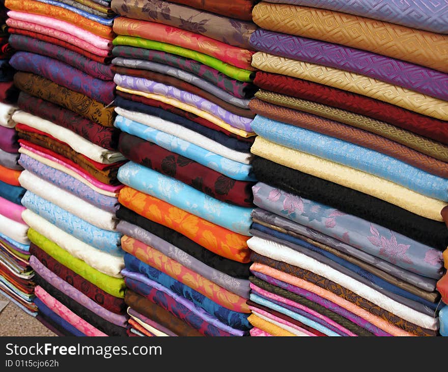 Colorful textiles with prints at a market. Colorful textiles with prints at a market