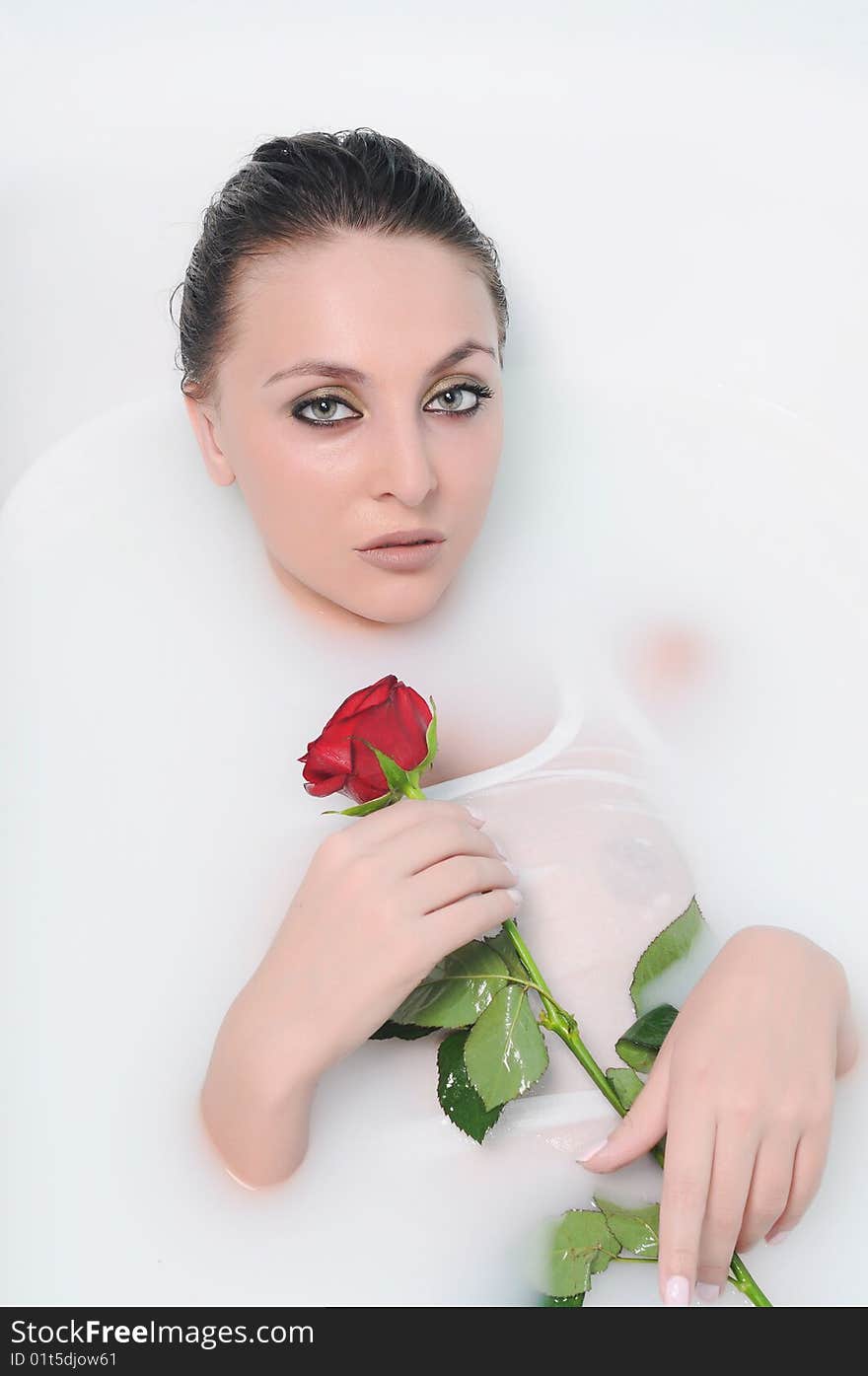 The beautiful woman in a bathroom with flowers