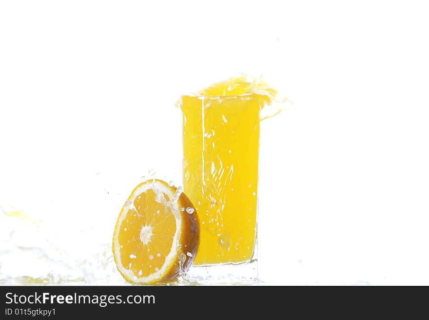 Oranges and glass of cold juice under splash. Oranges and glass of cold juice under splash