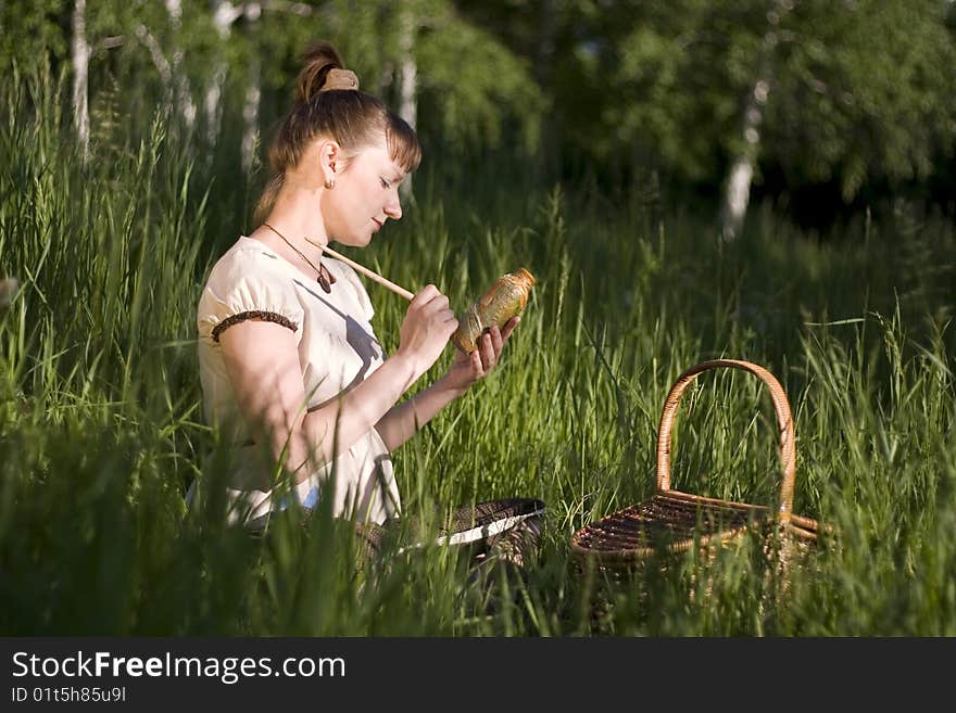 Pregnant woman sitting on grass and drawing bowl. Grecian style. Pregnant woman sitting on grass and drawing bowl. Grecian style.