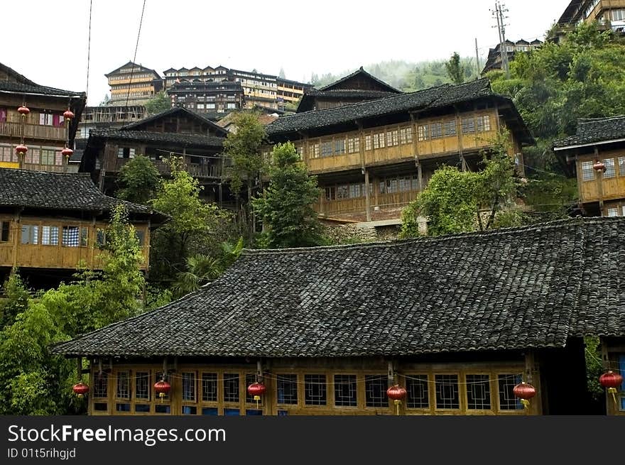 Chinese village Longshan in Guangxi province, near Guilin city. Wooden houses in high mountains, surrounded by terraced rice fields. Chinese village Longshan in Guangxi province, near Guilin city. Wooden houses in high mountains, surrounded by terraced rice fields.