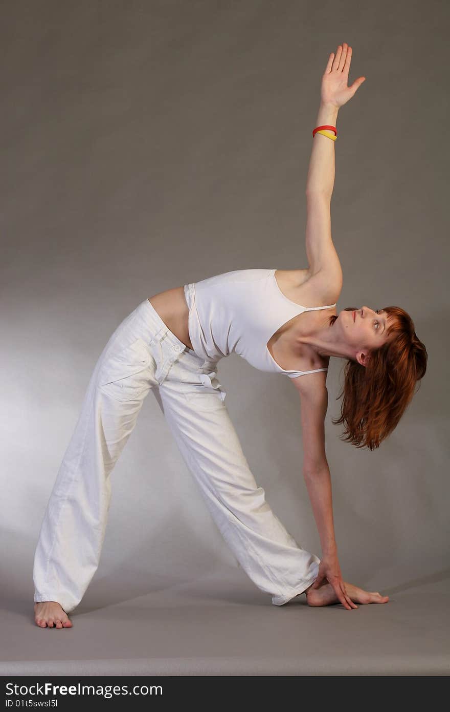 Girl practicing yoga on grey background