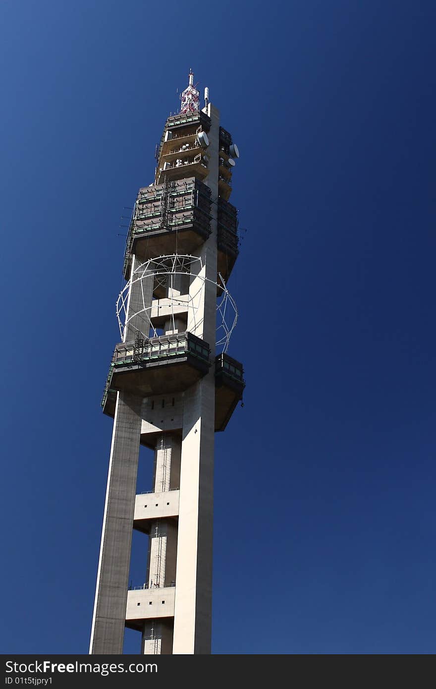 Large microwave tower build from concrete against a blue sky. Large microwave tower build from concrete against a blue sky