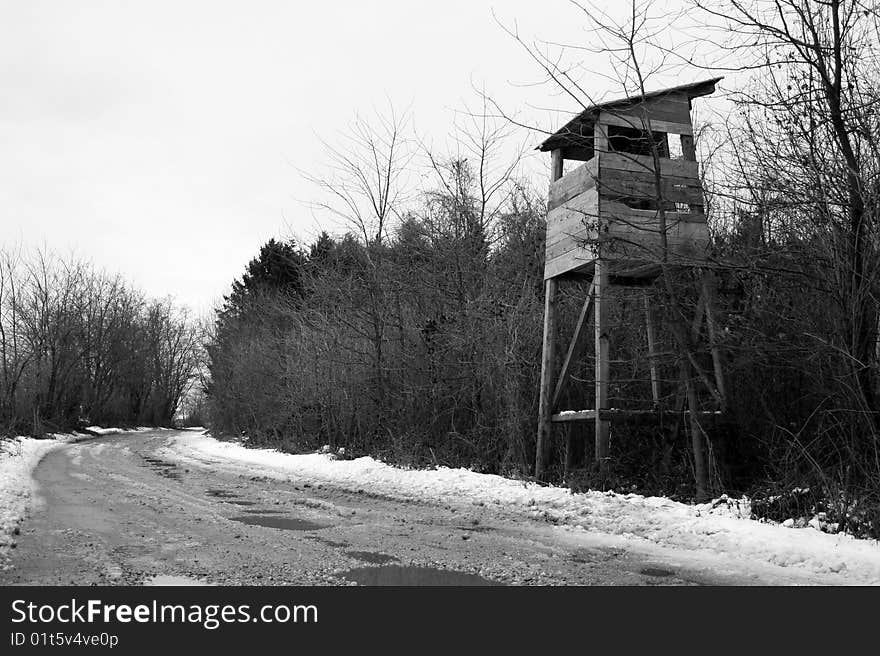 Old hunters lookout standing tall by the woods. Old hunters lookout standing tall by the woods