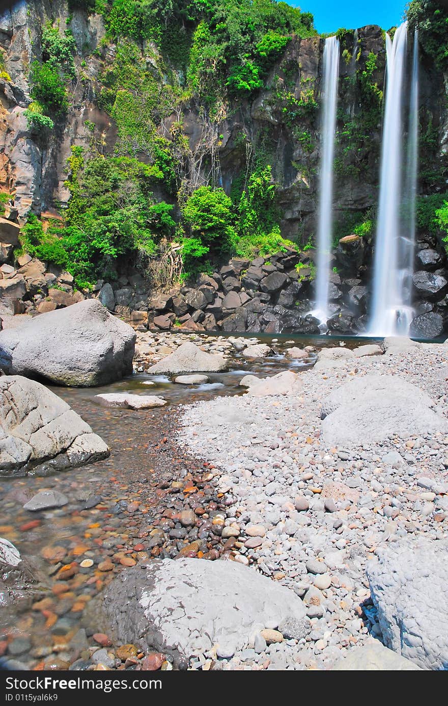 Low shot of majestic waterfall with sky background