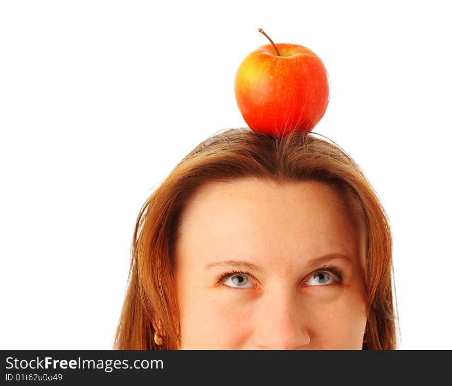 Cropped image of a young attractive woman with a juicy red apple on her head, isolated over white background. Cropped image of a young attractive woman with a juicy red apple on her head, isolated over white background