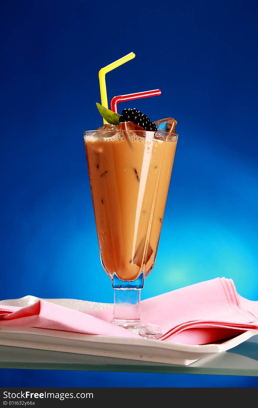 Colourful appetising cocktail with fruit on blue background. Colourful appetising cocktail with fruit on blue background