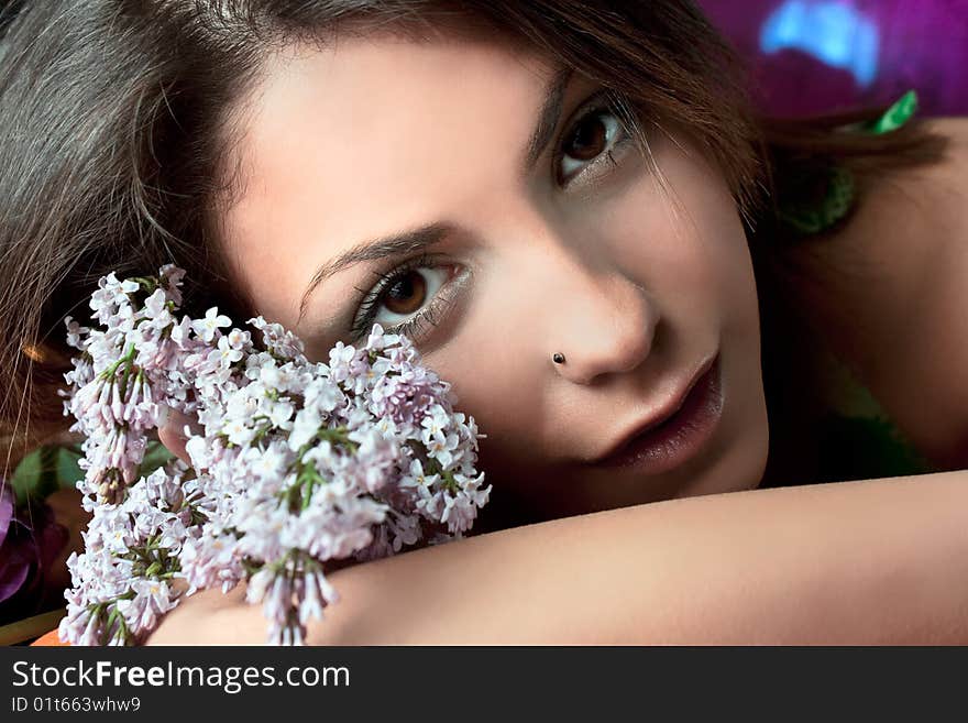 Pretty woman with flowers  in summer time