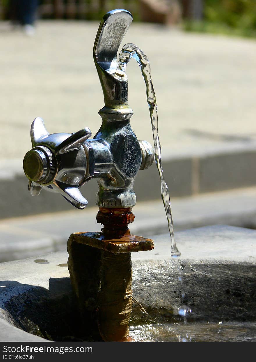 An old and rusted watering fountain. An old and rusted watering fountain