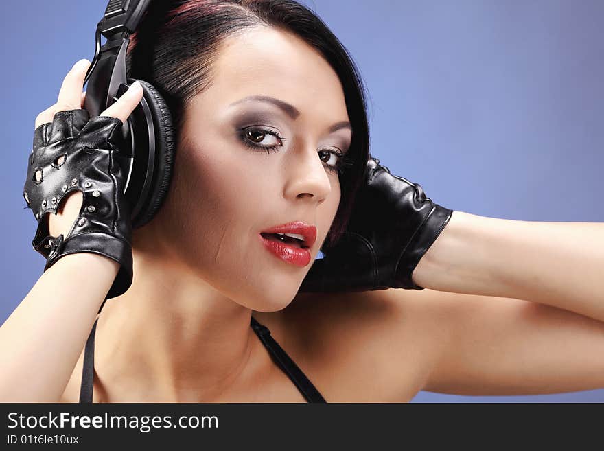 Girl listening to music over a blue moving background. Girl listening to music over a blue moving background