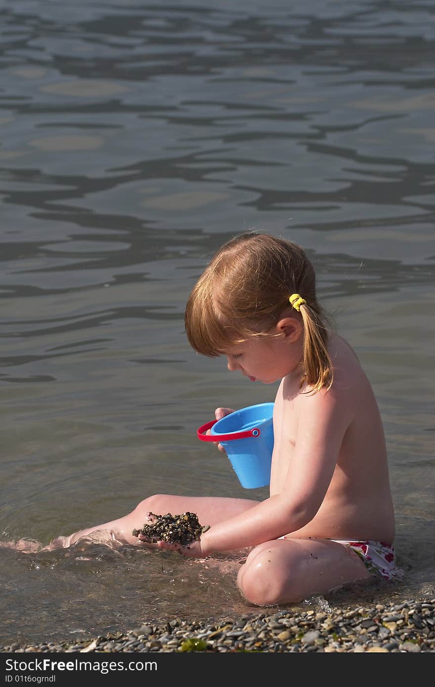 Little girl playing in the sea. Little girl playing in the sea