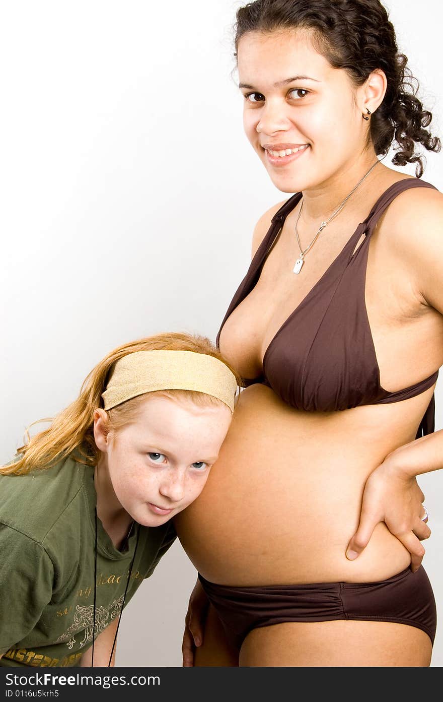 Little Girl Is Listening To The Baby