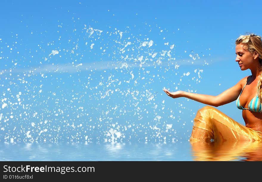 Blonde mermaid sitting in water and splashes all around with relection. Blonde mermaid sitting in water and splashes all around with relection