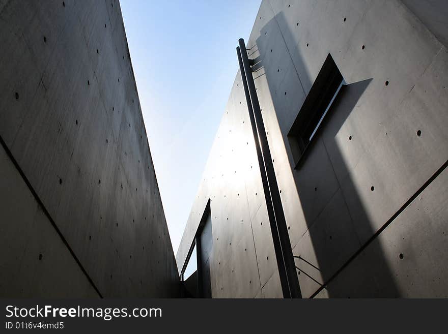 Sharp modernist building with blue sky, Osaka, Japan.