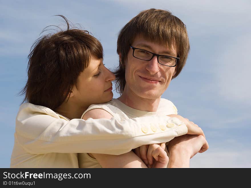 Boy and girl on the river`s bank