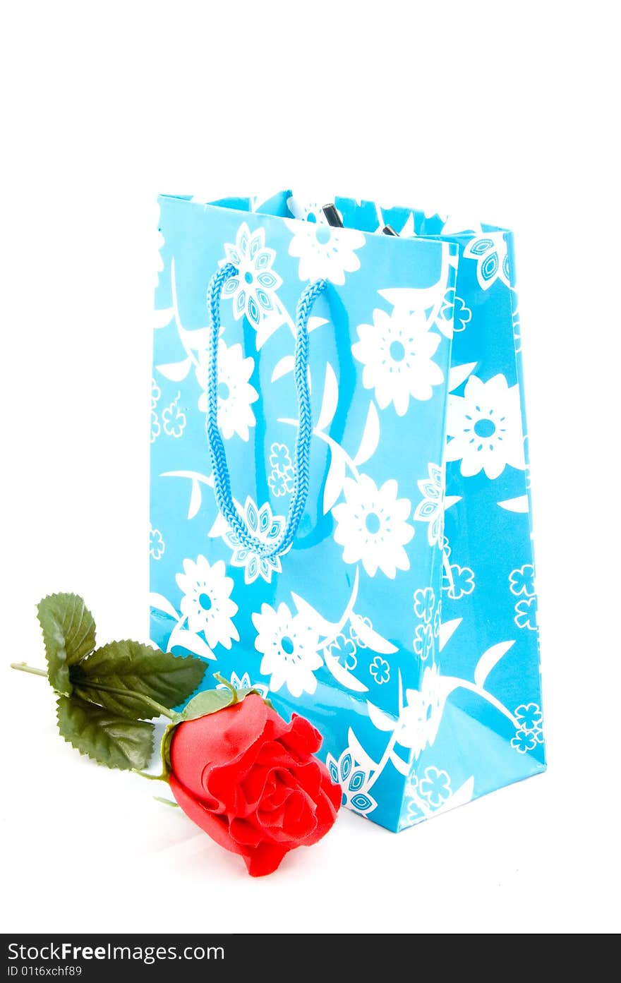 Empty paper shopping bag with handles with red rose isolated. Empty paper shopping bag with handles with red rose isolated