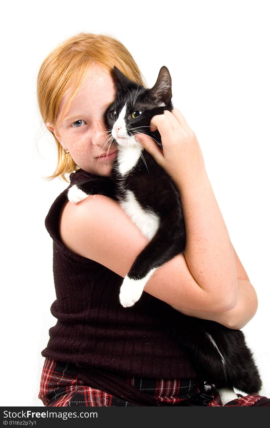 Girl is cuddling with a young cat isolated on white