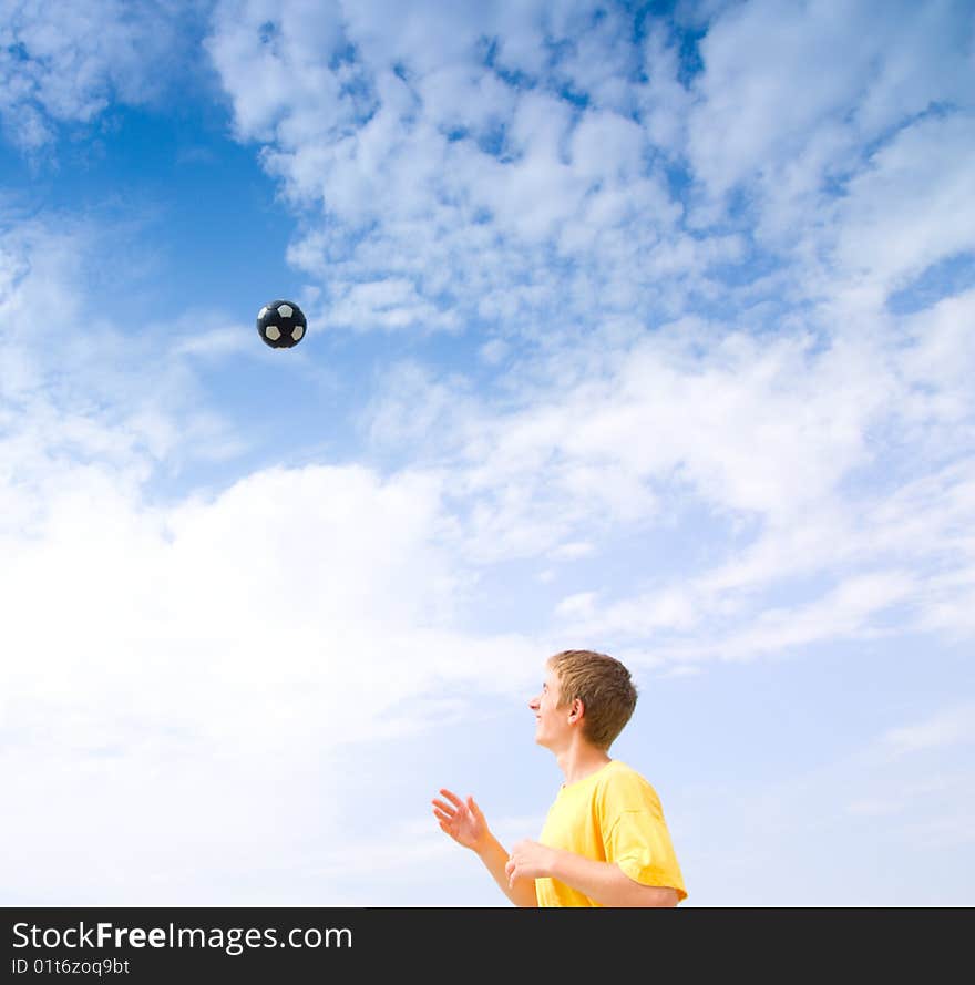 A teenager knocked up a ball upwards. A teenager knocked up a ball upwards