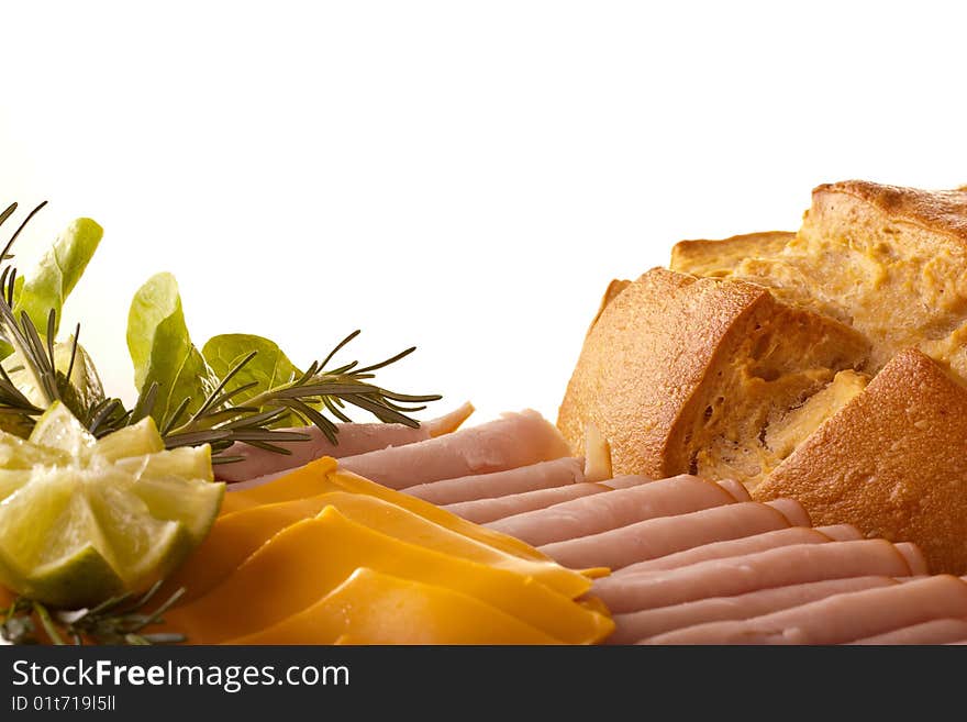 An italian bread with some slices of ham and cheese, over an white background. An italian bread with some slices of ham and cheese, over an white background