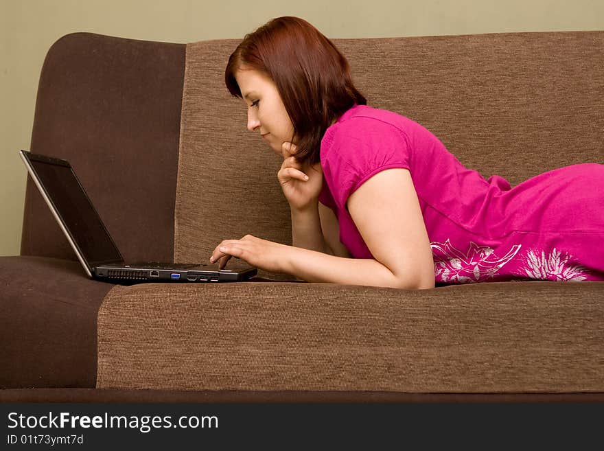 Woman with laptop on sofa