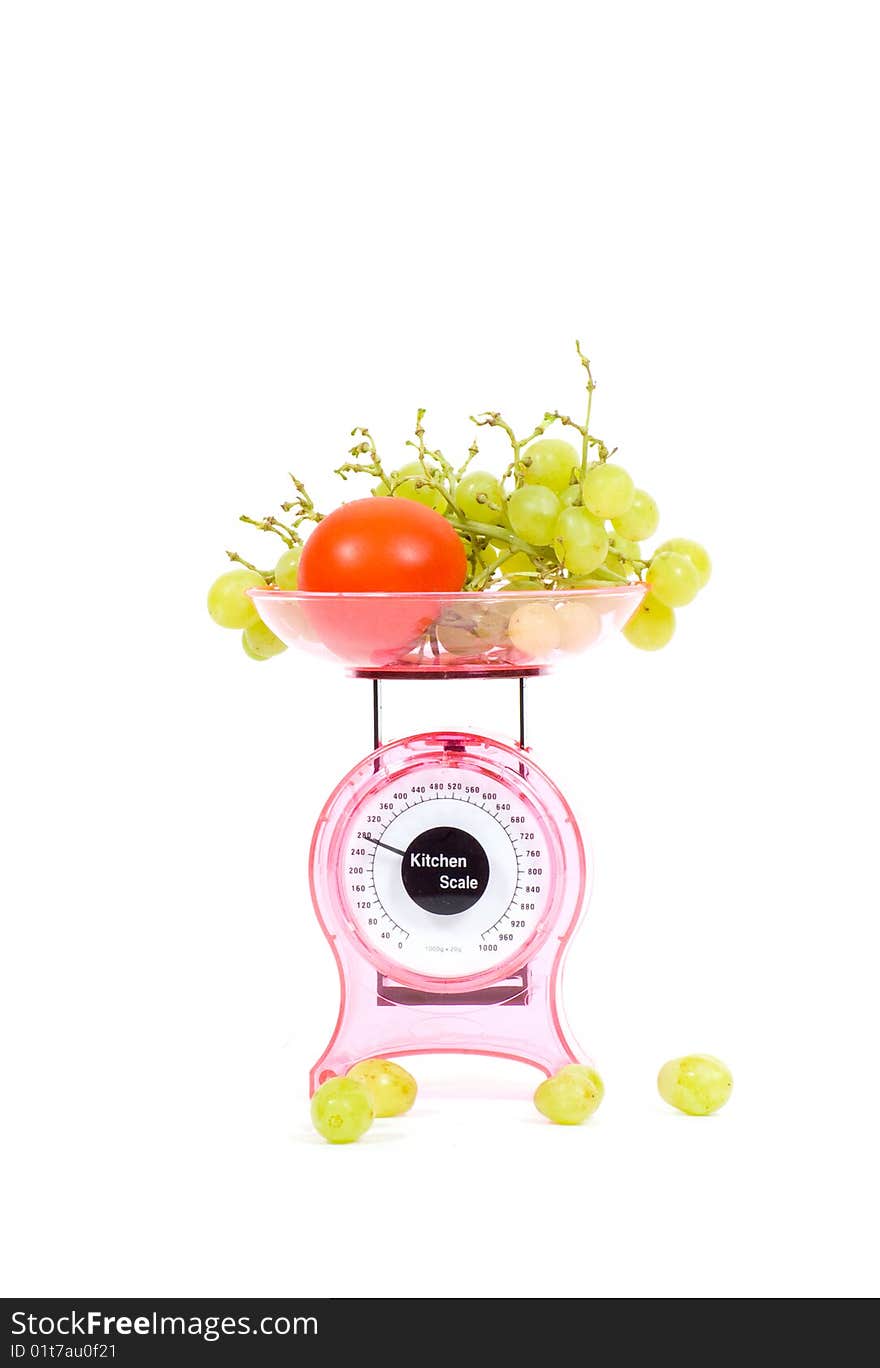 Kitchen Scales with fresh tomatoes and grapes  isolated over white