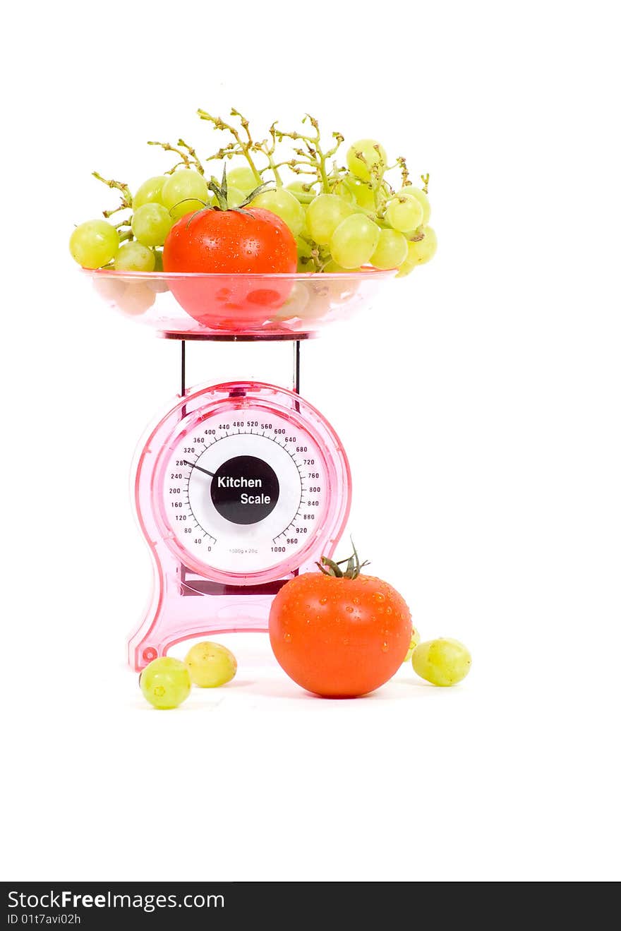 Kitchen Scales with tomatoes and grapes isolated over white