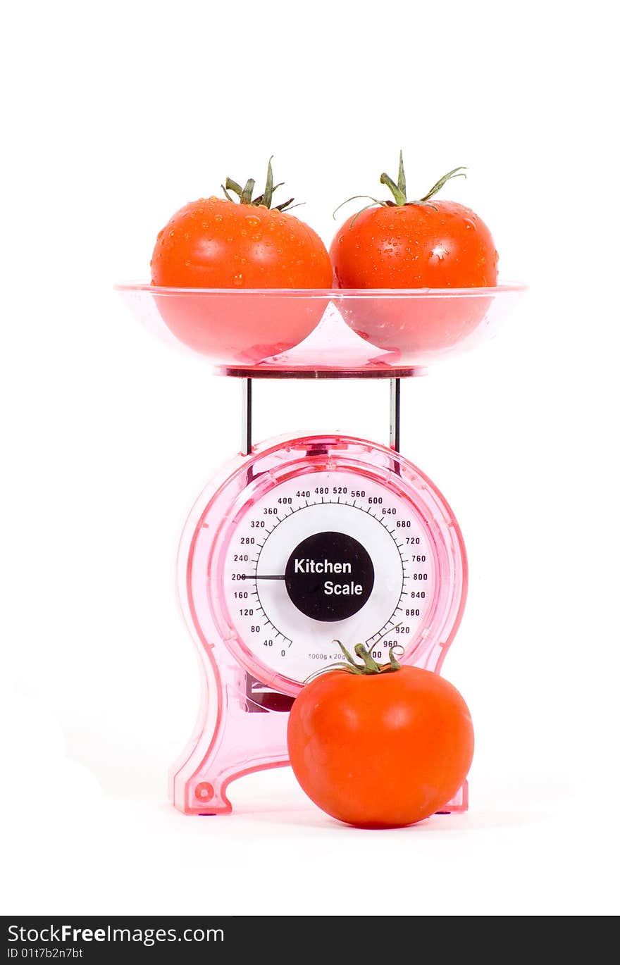 Kitchen Scales with fresh tomatoes isolated over white