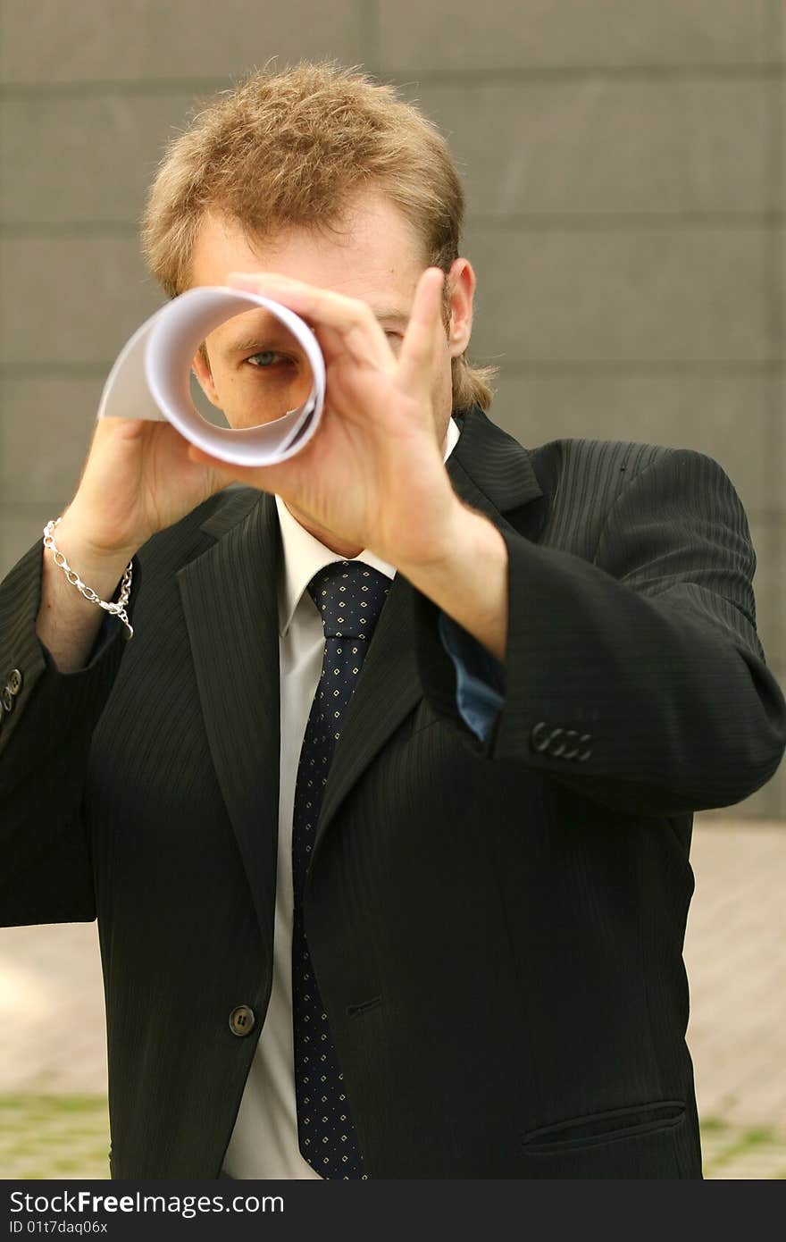 Man Looking Through Paper