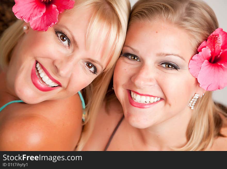 Beautiful Smiling Girls with Hibiscus Flowers in Their Hair.