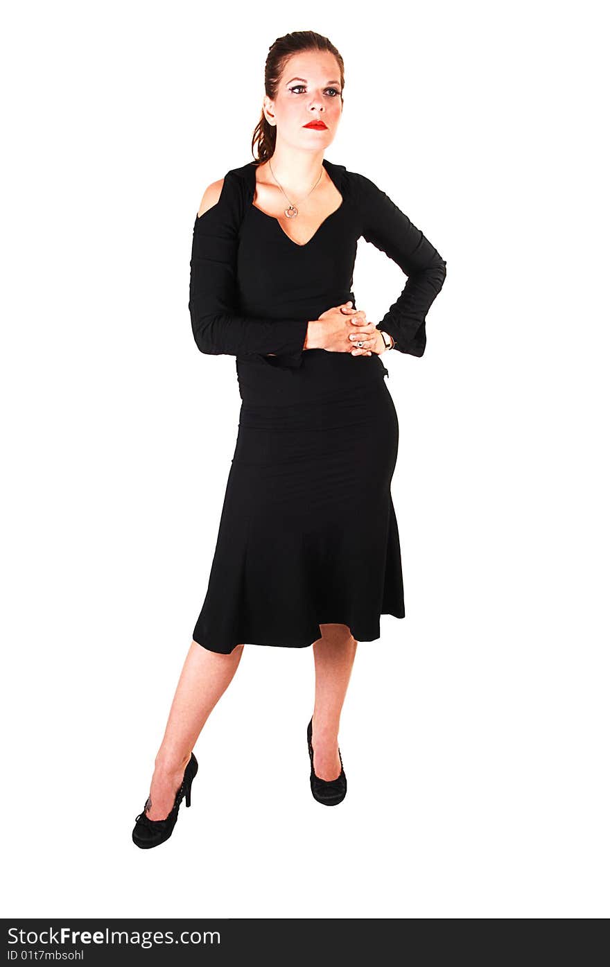 Young lovely girl in a black dress with red lips and high heels standing in the studio for white background. Young lovely girl in a black dress with red lips and high heels standing in the studio for white background.