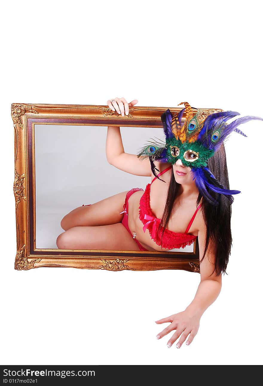 Lovely woman in red lingerie with a mask over her face looking through a picture frame with gray background inside and white background outside. Lovely woman in red lingerie with a mask over her face looking through a picture frame with gray background inside and white background outside.