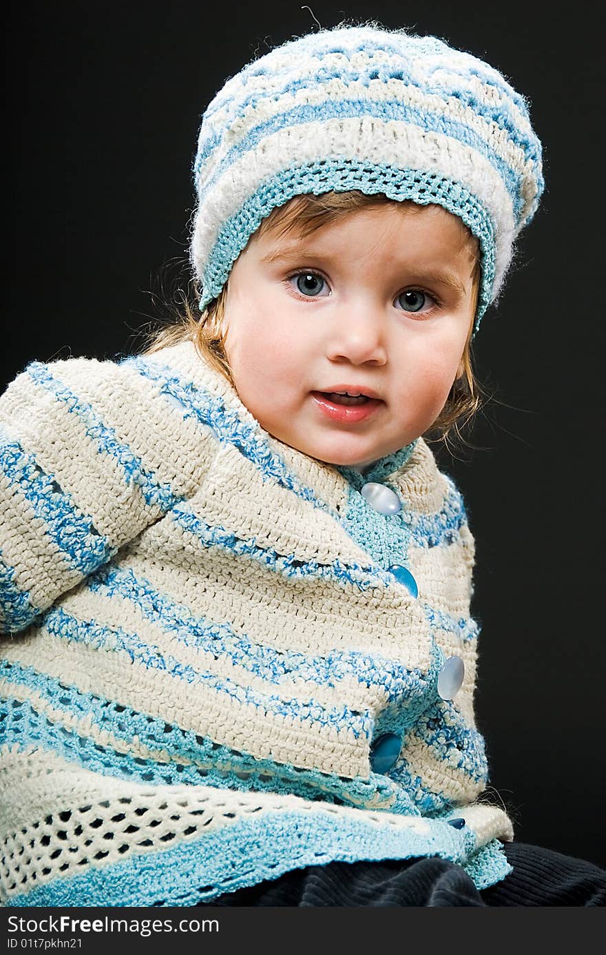 Little baby in a bound suit on black background. Little baby in a bound suit on black background