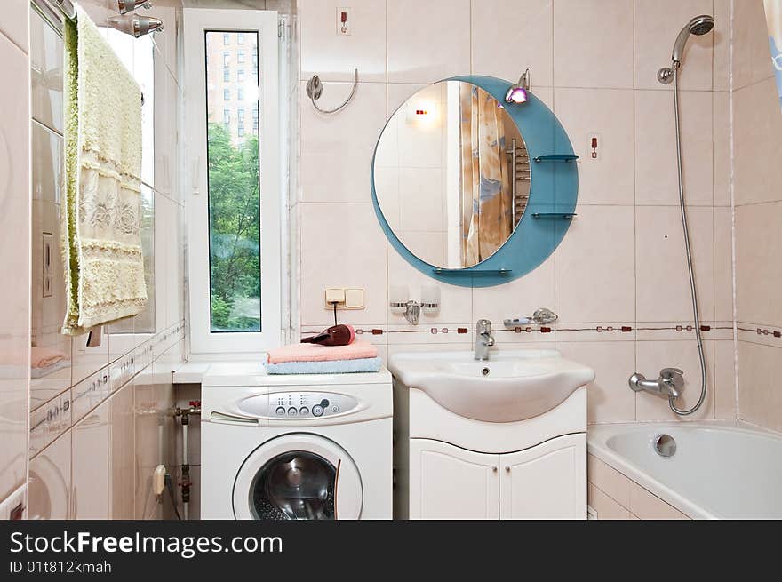 Lamp and mirror on a wall of bathroom