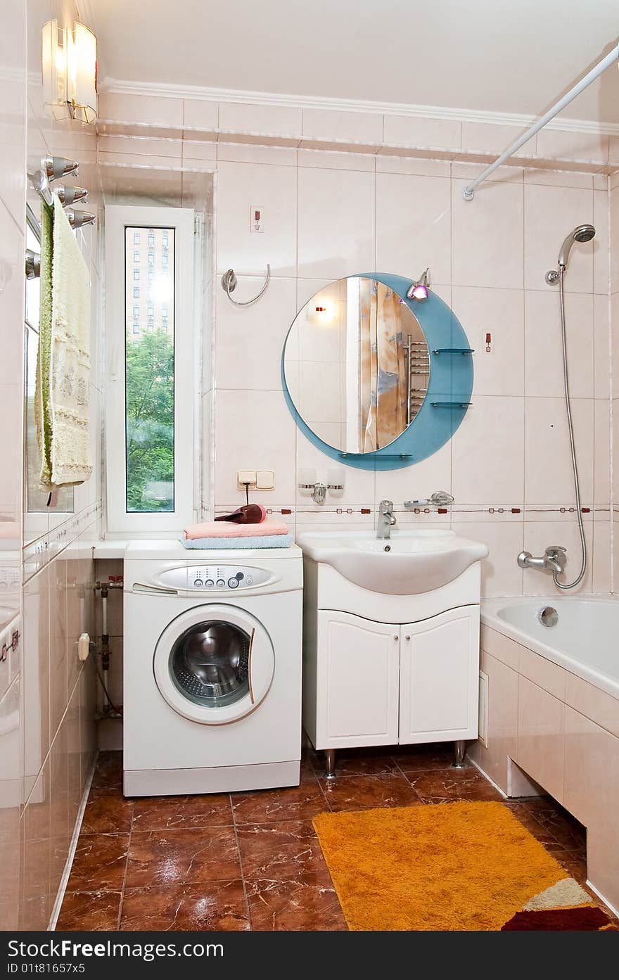 Lamp and mirror on a wall of bathroom