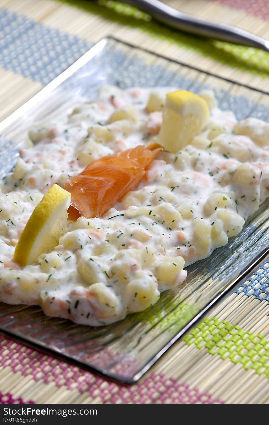 Potato halusky (dumplings) with smoked salmon (Slovakian cuisine)