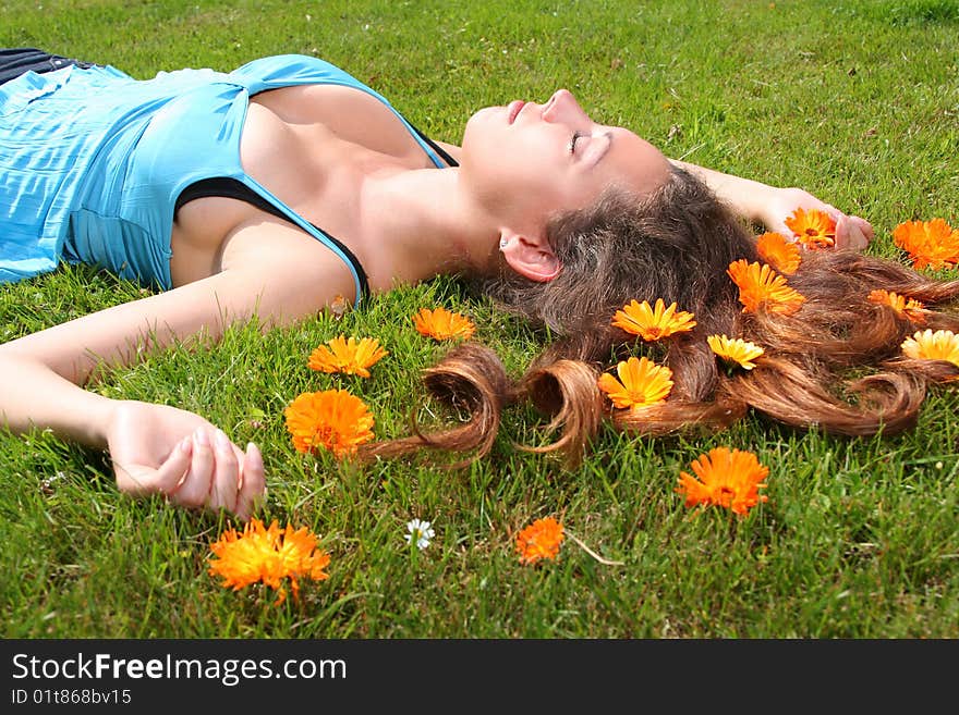 Beautiful young woman relaxing on a grass. Beautiful young woman relaxing on a grass