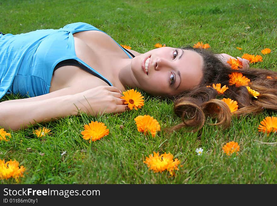 Beautiful young woman relaxing on a grass. Beautiful young woman relaxing on a grass