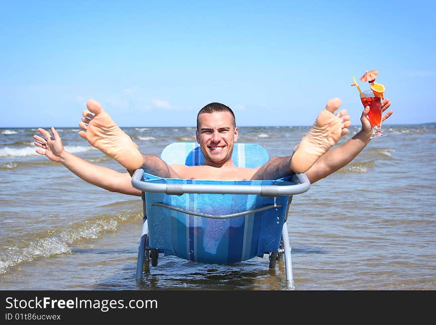 Young guy relaxing with cocktail. Young guy relaxing with cocktail