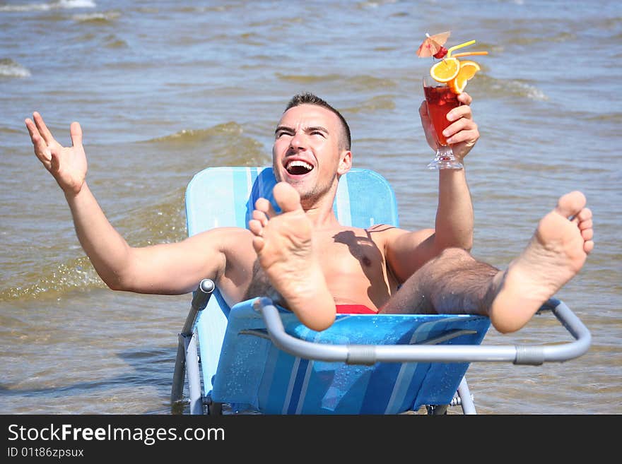 Young guy relaxing with cocktail. Young guy relaxing with cocktail