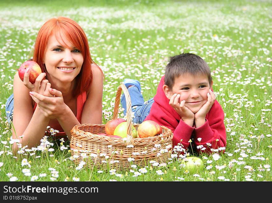 Happy young family relaxing on a meadow. Happy young family relaxing on a meadow