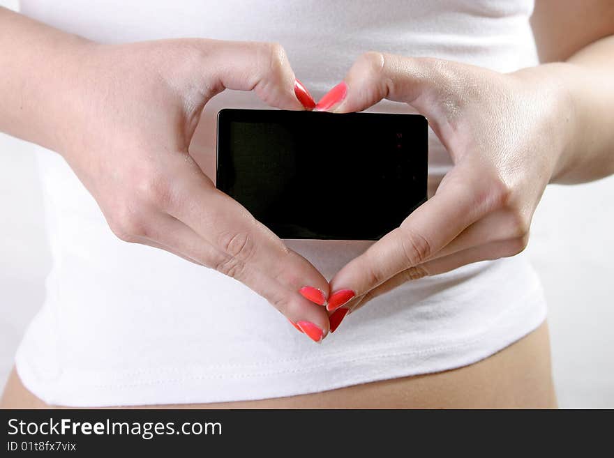 Close up of young and beautiful woman hands forming heard with hands and holding black plate. Close up of young and beautiful woman hands forming heard with hands and holding black plate.